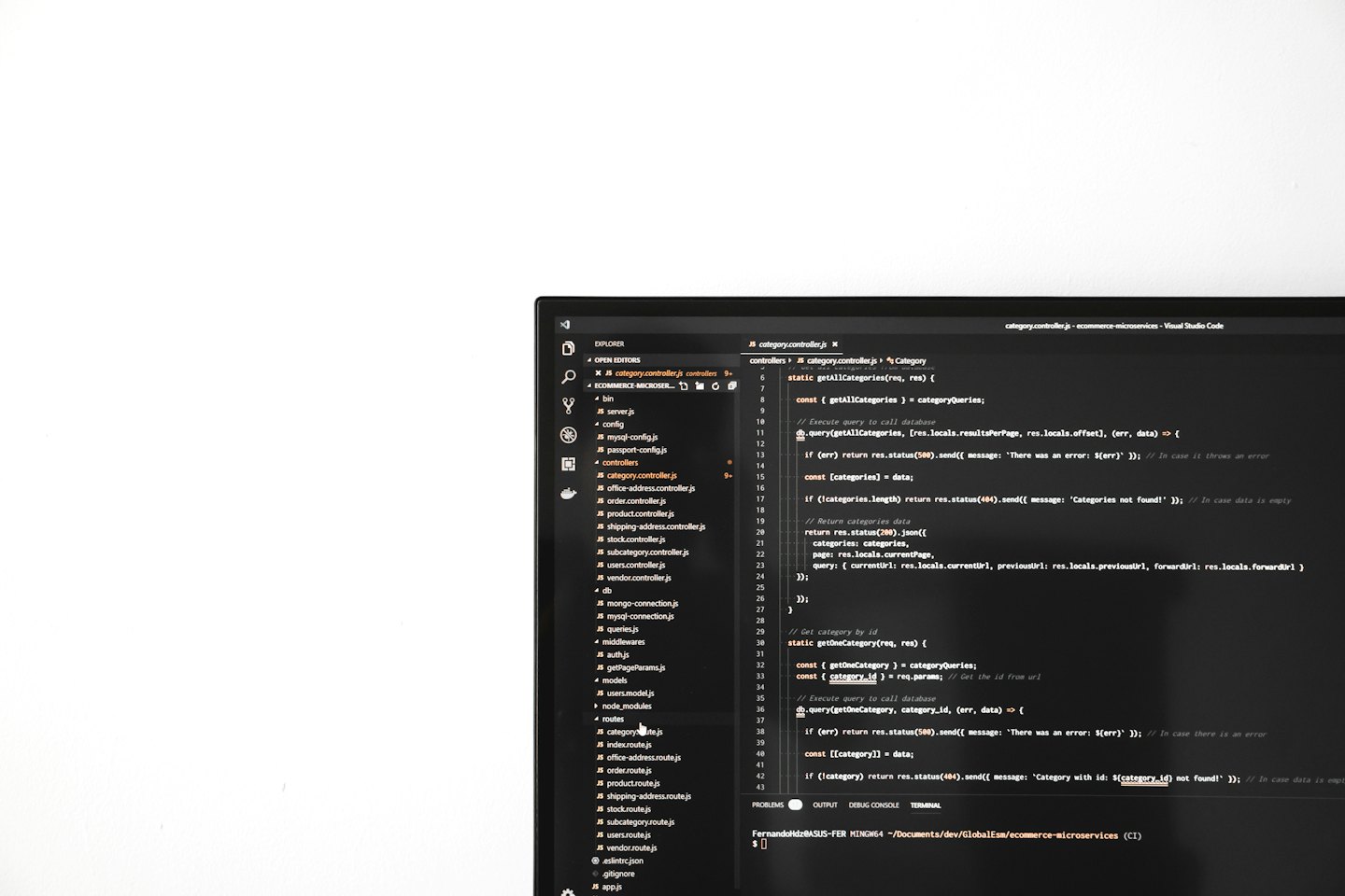 Computer monitor displaying JavaScript code in a dark theme.