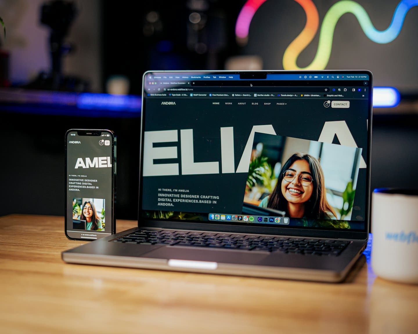 Laptop and smartphone showing a professional website on a wooden desk.